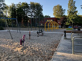 Ein leerer Spielplatz mit einigen Spielgeräten.