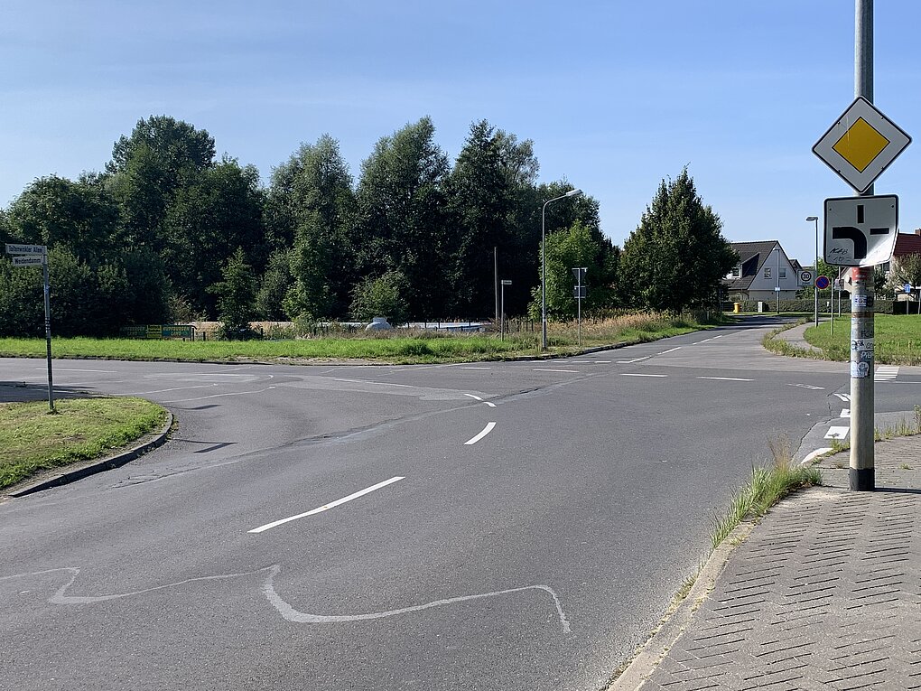 Leere Straßenkreuzung mit Markierungen.